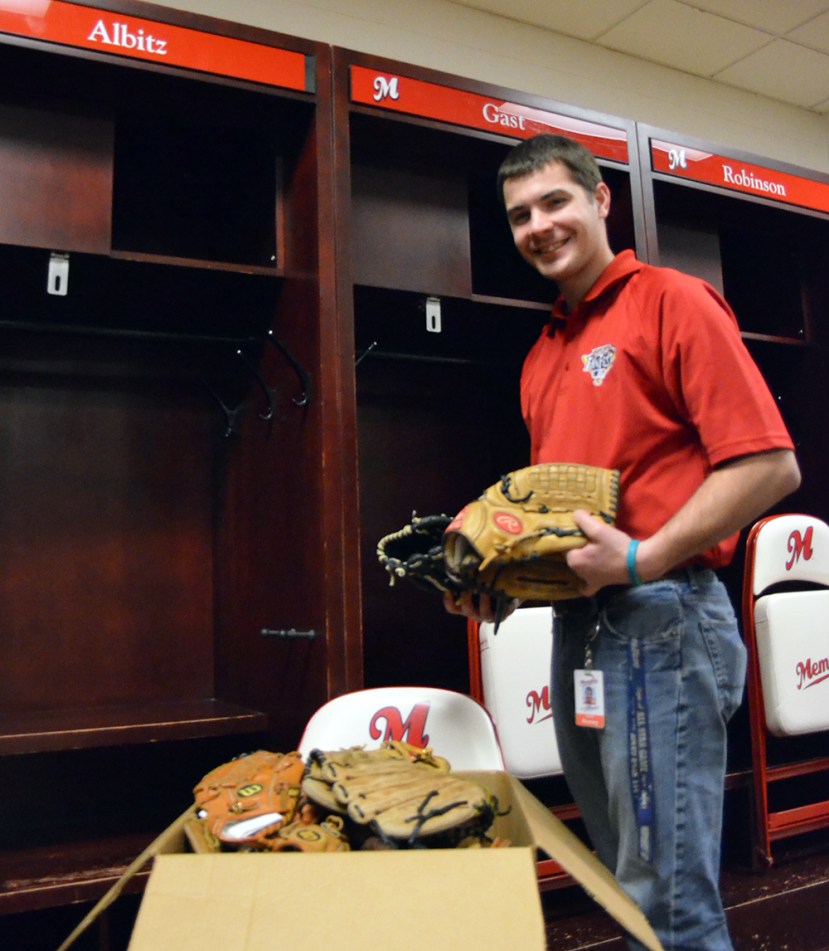 Redbirds Director of Operations Mark Anderson with box of donated gloves besides Albitz Locker. 